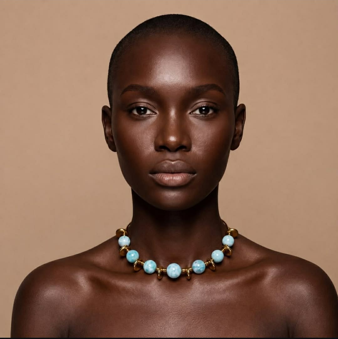 Editorial portrait wearing a turquoise and gold necklace