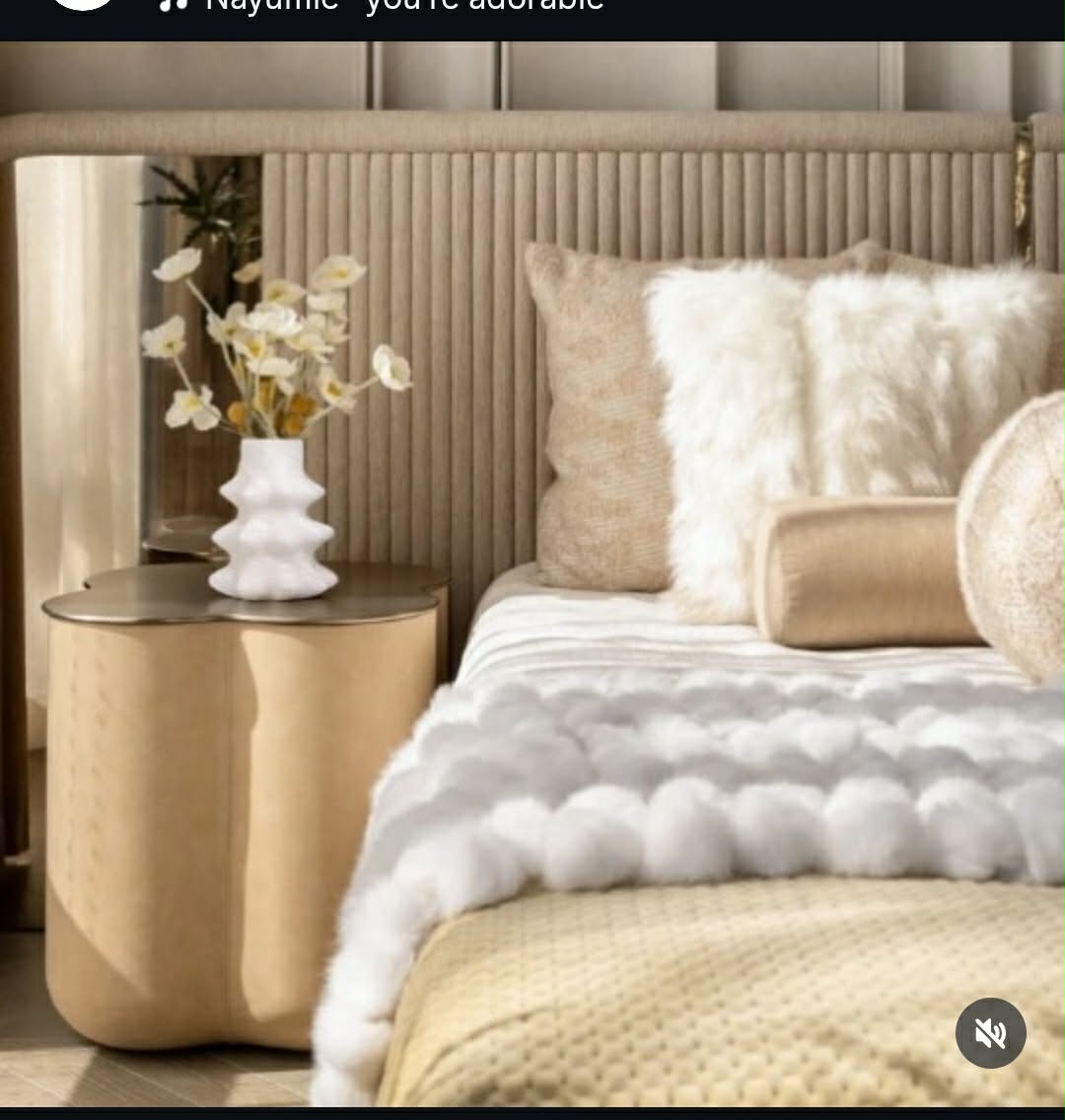 Layered neutral bedroom styled with sculptural furniture and tactile textiles